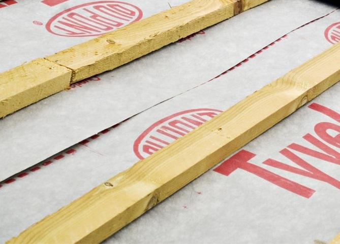 Closeup of DuPont Tyvek breather membrane with roof batten sitting on top of it.