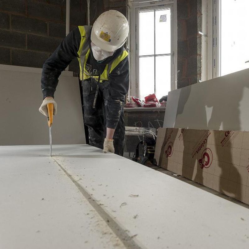 Man cutting insulation board