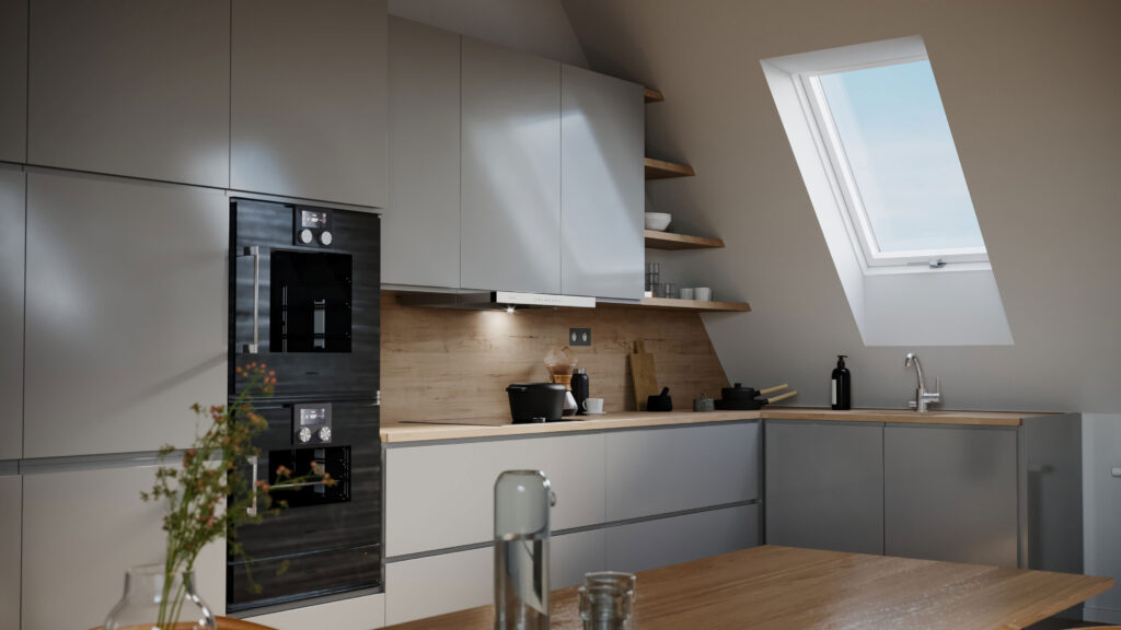 RoofLITE+ white PVC pitched roof window in a modern kitchen with light wood counter tops, grey cupboards, and a double oven. The light from the window is brightening the entire space